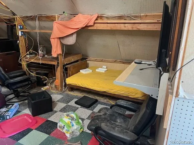 a living room with furniture a rug and a wall painting