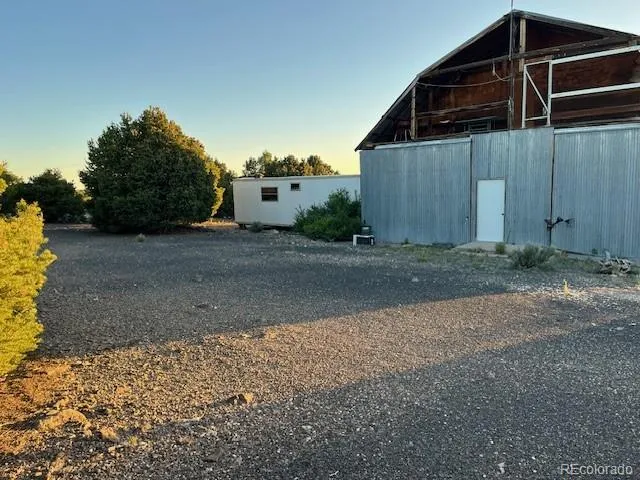 a view of a wooden door with a yard