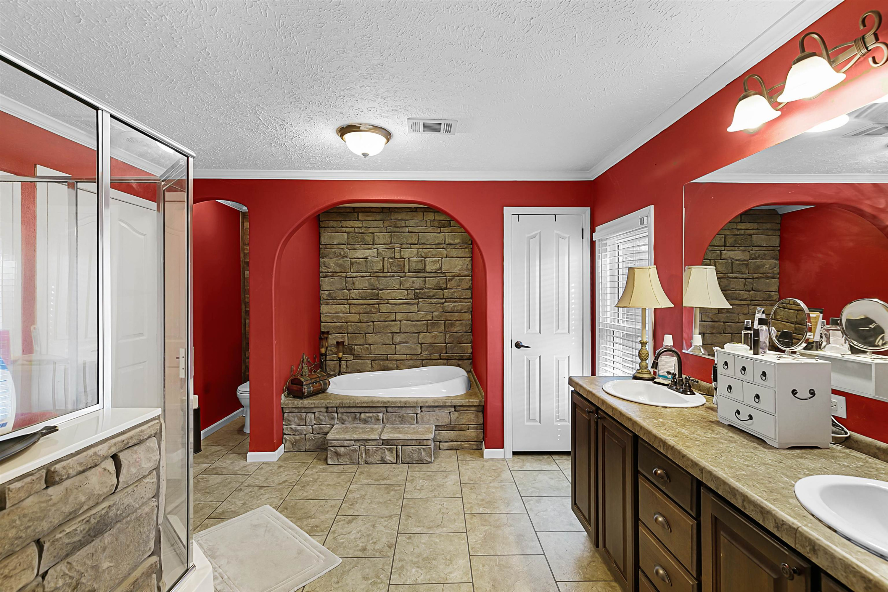 828 Browns Church Road Jackson, TN 38305 - Photo 11 of 26 a bathroom with a sink a toilet and a mirror