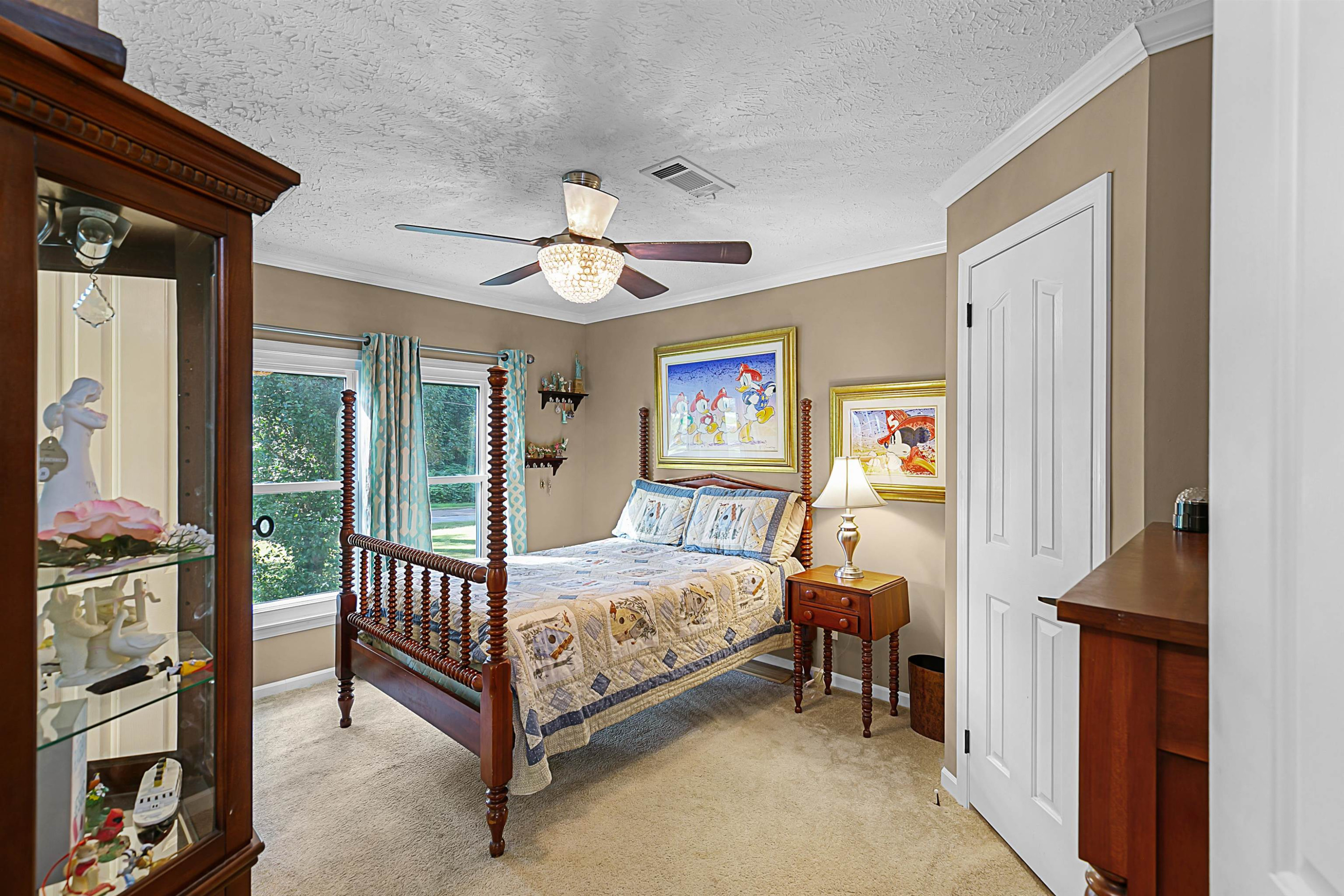 828 Browns Church Road Jackson, TN 38305 - Photo 13 of 26 a bedroom with a bed and a chandelier