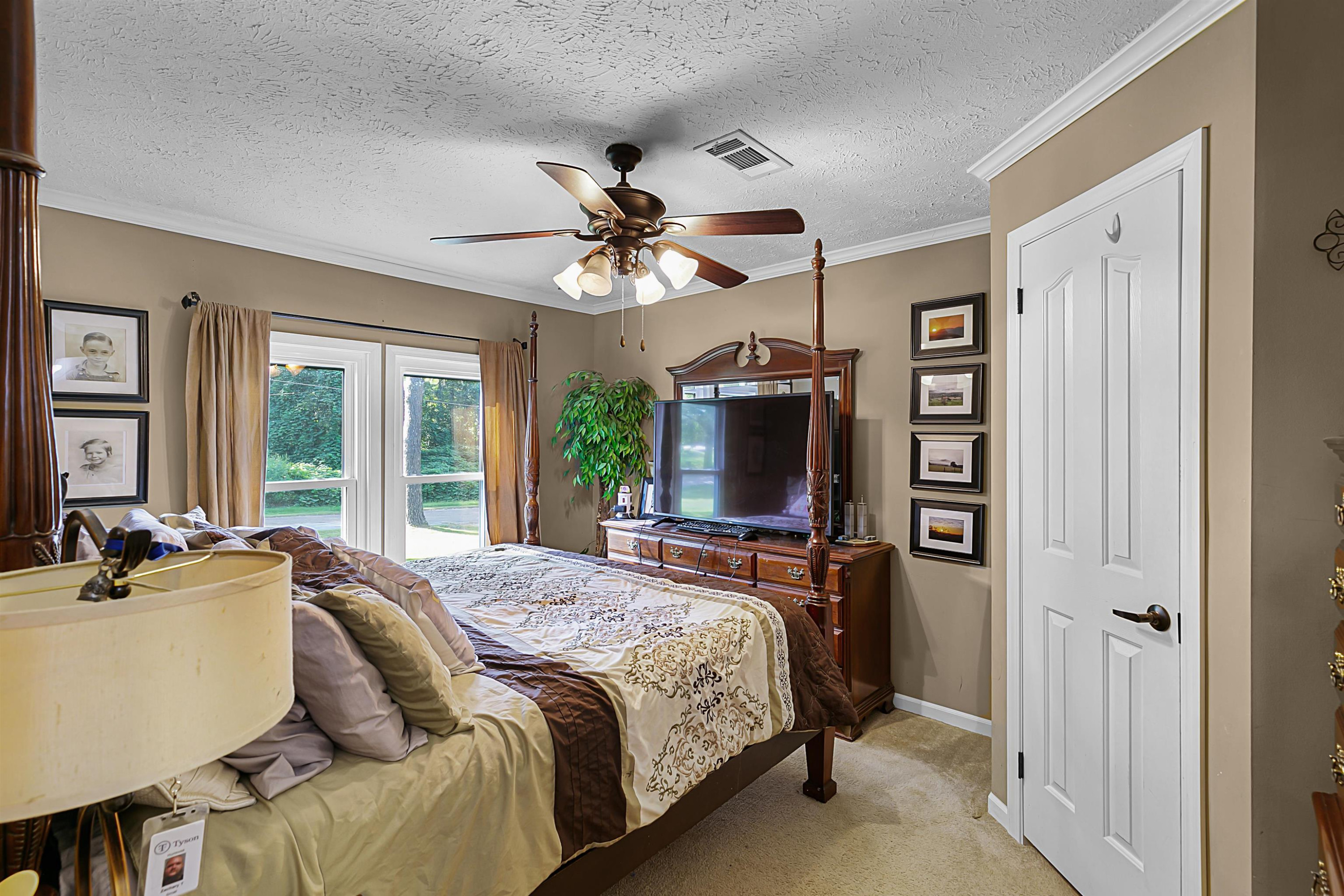 828 Browns Church Road Jackson, TN 38305 - Photo 17 of 26 a bedroom with a bed and a flat screen tv