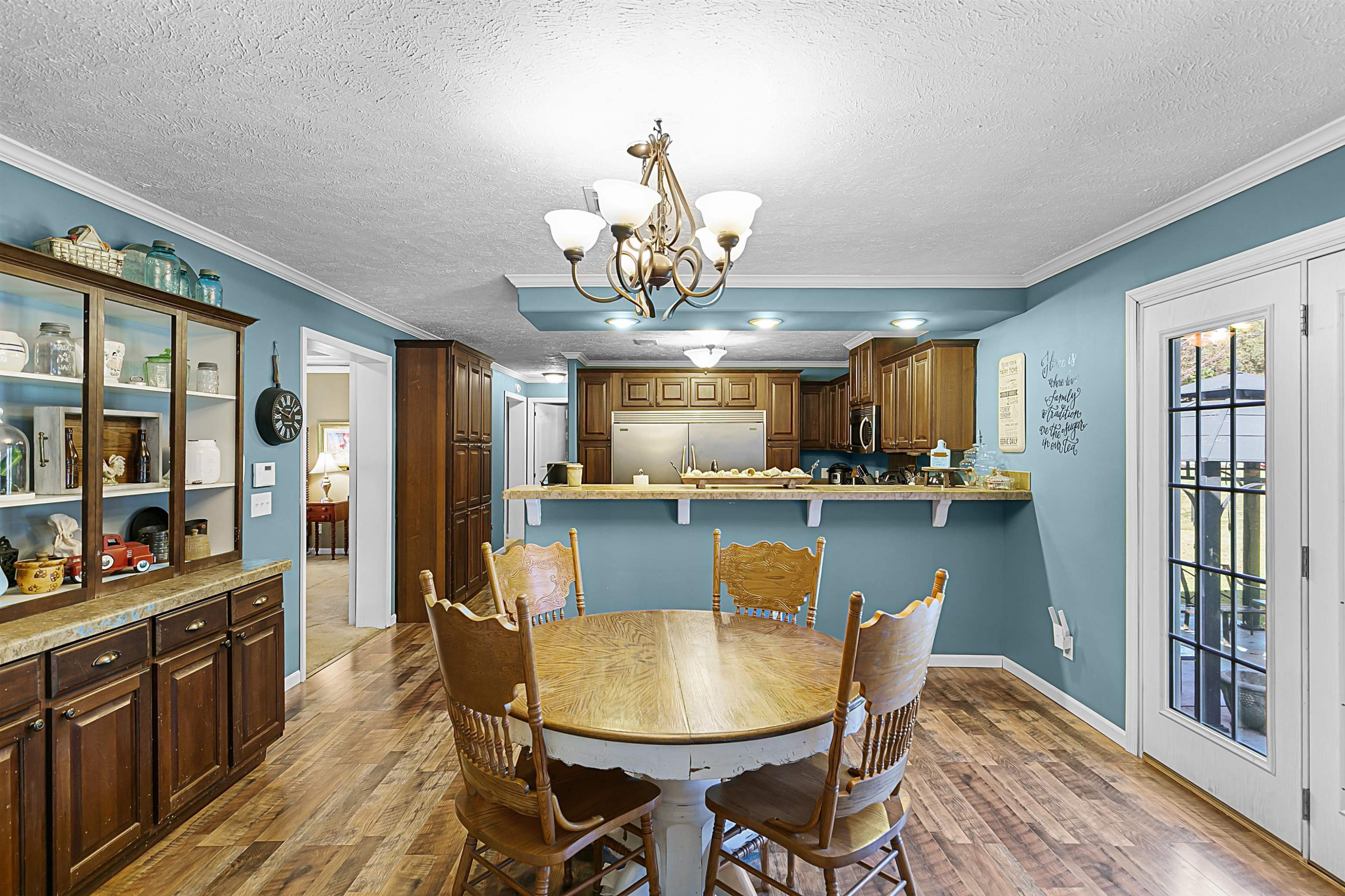 828 Browns Church Road Jackson, TN 38305 - Photo 6 of 26 a view of a dining room with furniture window and wooden floor