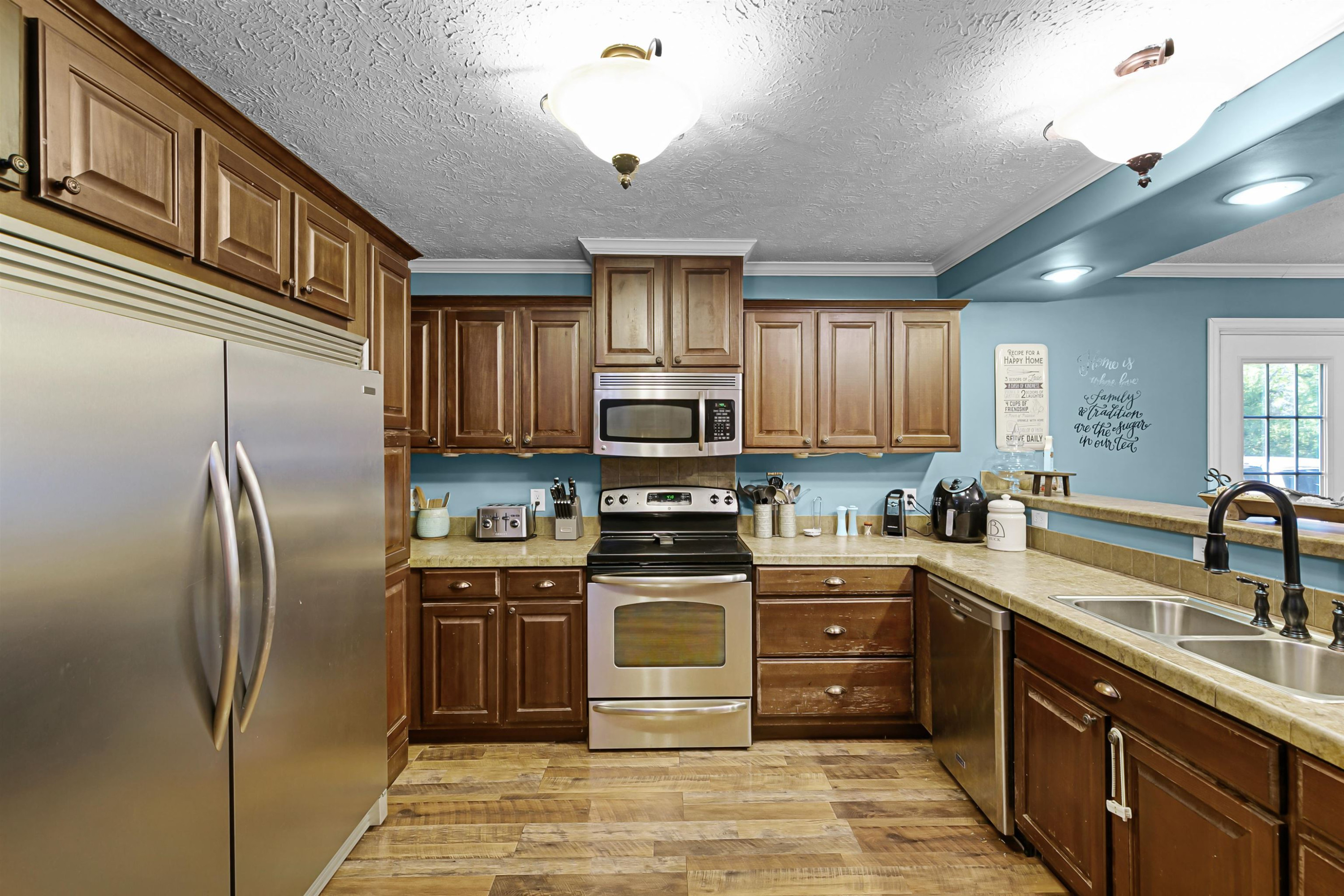 828 Browns Church Road Jackson, TN 38305 - Photo 7 of 26 a kitchen with stainless steel appliances granite countertop a refrigerator stove top oven a sink and dishwasher