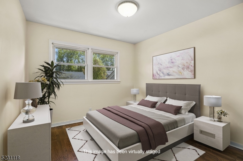 11 North Derby Road Springfield, NJ 07081 - Photo 11 of 30 a bedroom with a bed and wooden floor