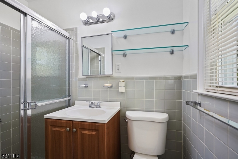 11 North Derby Road Springfield, NJ 07081 - Photo 12 of 30 a bathroom with a sink a toilet and shower