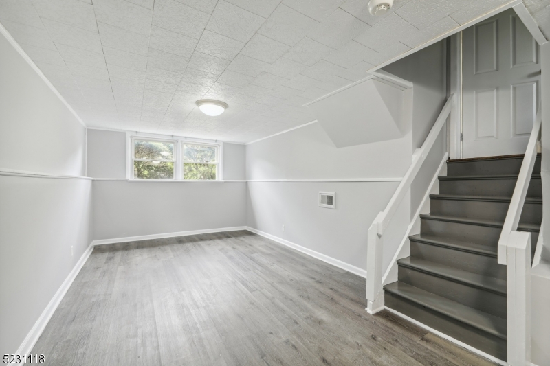 11 North Derby Road Springfield, NJ 07081 - Photo 13 of 30 a view of an empty room with wooden floor and stairs