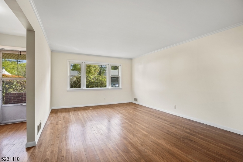 11 North Derby Road Springfield, NJ 07081 - Photo 17 of 30 an empty room with wooden floor and windows