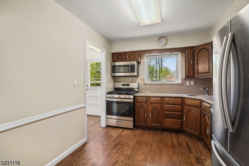 11 North Derby Road Springfield, NJ 07081 - Photo 20 of 30 a kitchen with stainless steel appliances granite countertop a stove a sink and a refrigerator