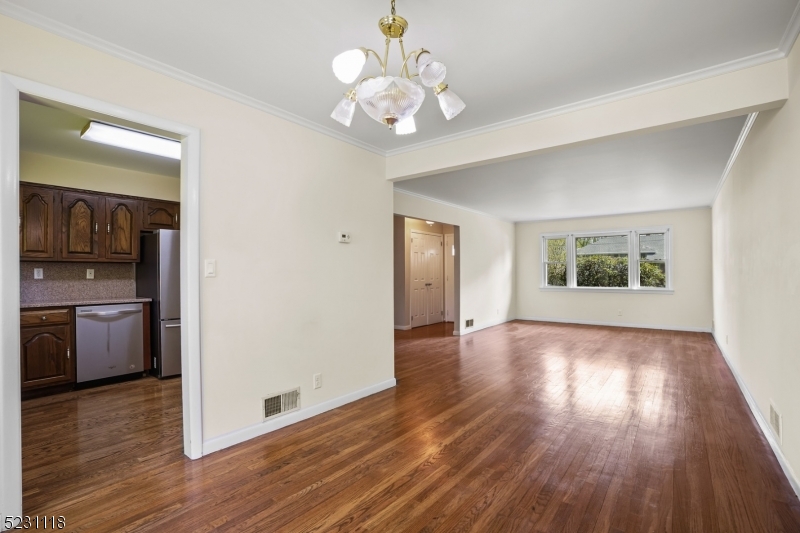 11 North Derby Road Springfield, NJ 07081 - Photo 22 of 30 a view of an empty room with a window and wooden floor