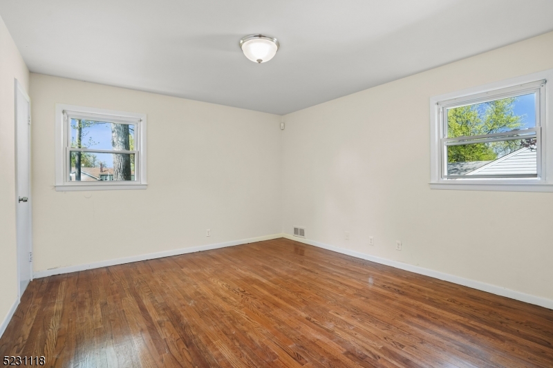 11 North Derby Road Springfield, NJ 07081 - Photo 23 of 30 a view of empty room with wooden floor and fan