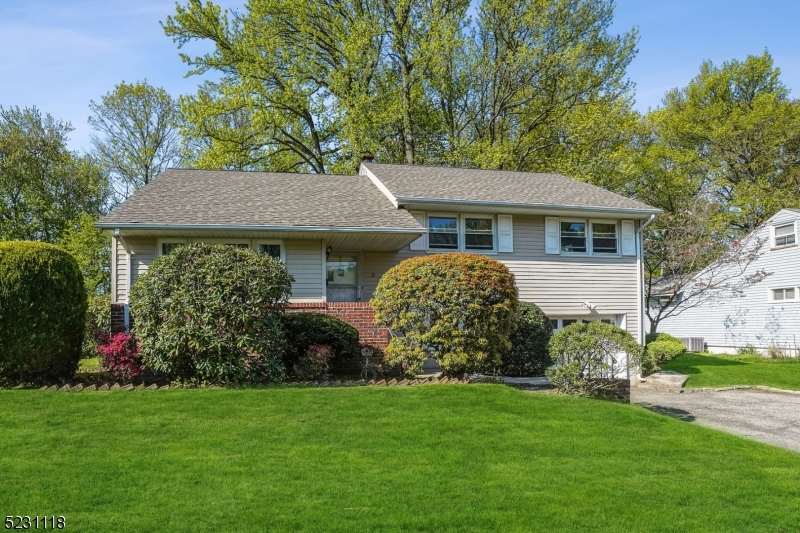 11 North Derby Road Springfield, NJ 07081 - Photo 30 of 30 a front view of a house with garden