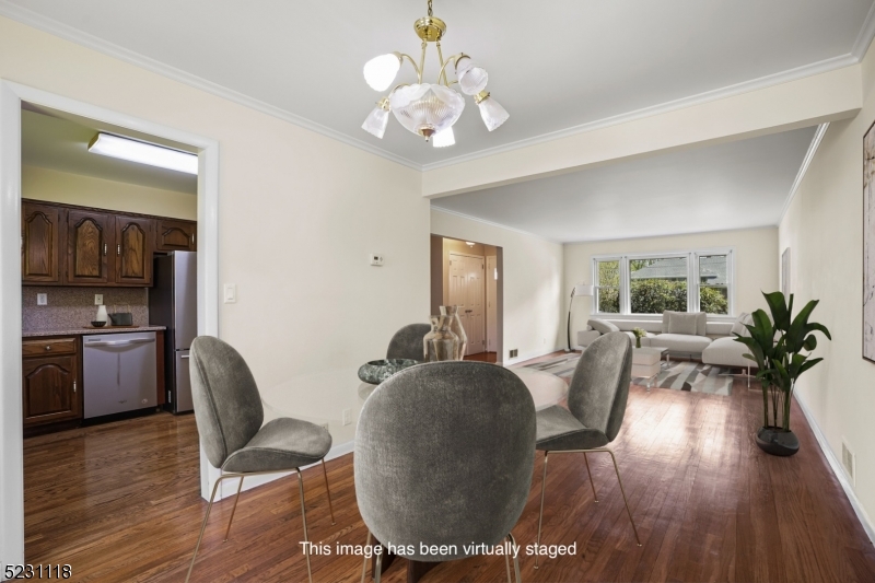 11 North Derby Road Springfield, NJ 07081 - Photo 4 of 30 a living room with furniture chandelier and wooden floor