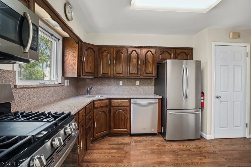 11 North Derby Road Springfield, NJ 07081 - Photo 5 of 30 a kitchen with stainless steel appliances granite countertop a refrigerator stove and sink