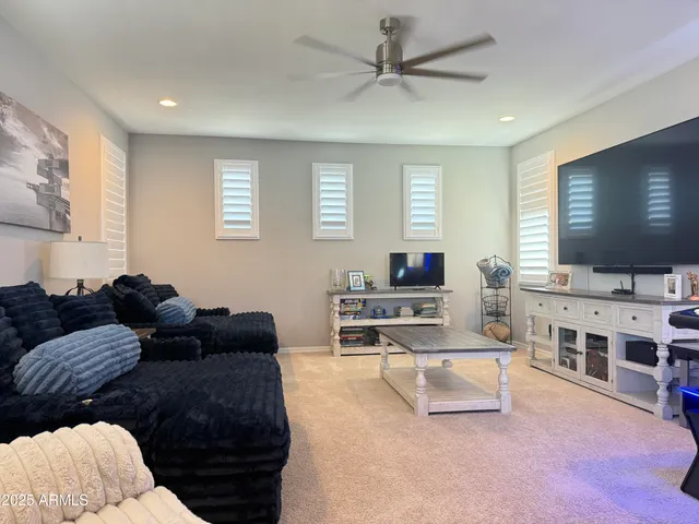 a view of a hallway to a livingroom with furniture