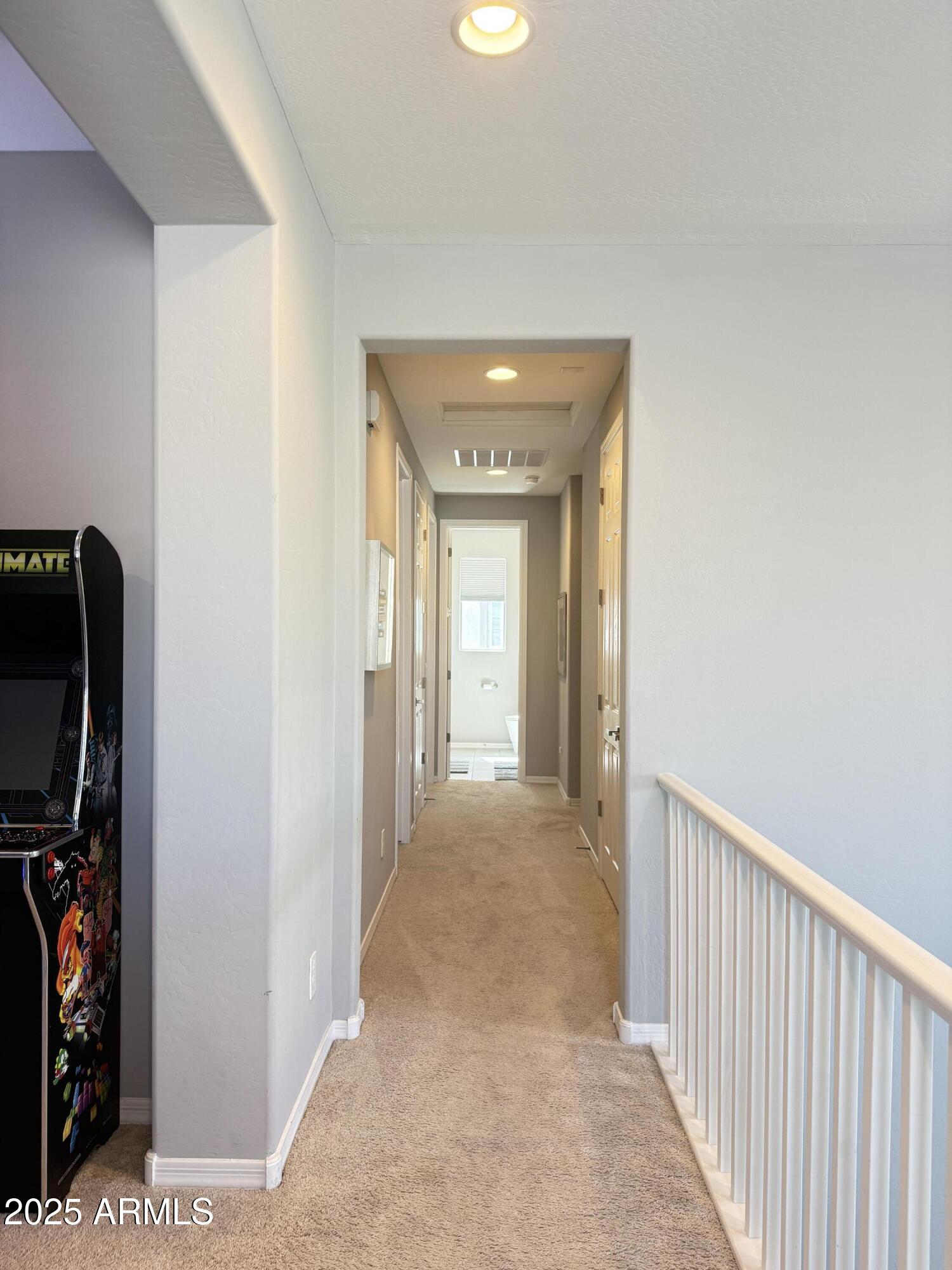 6980 West Redbird Road Peoria, AZ 85383 - Photo 15 of 31 a view of a hallway to a livingroom with furniture