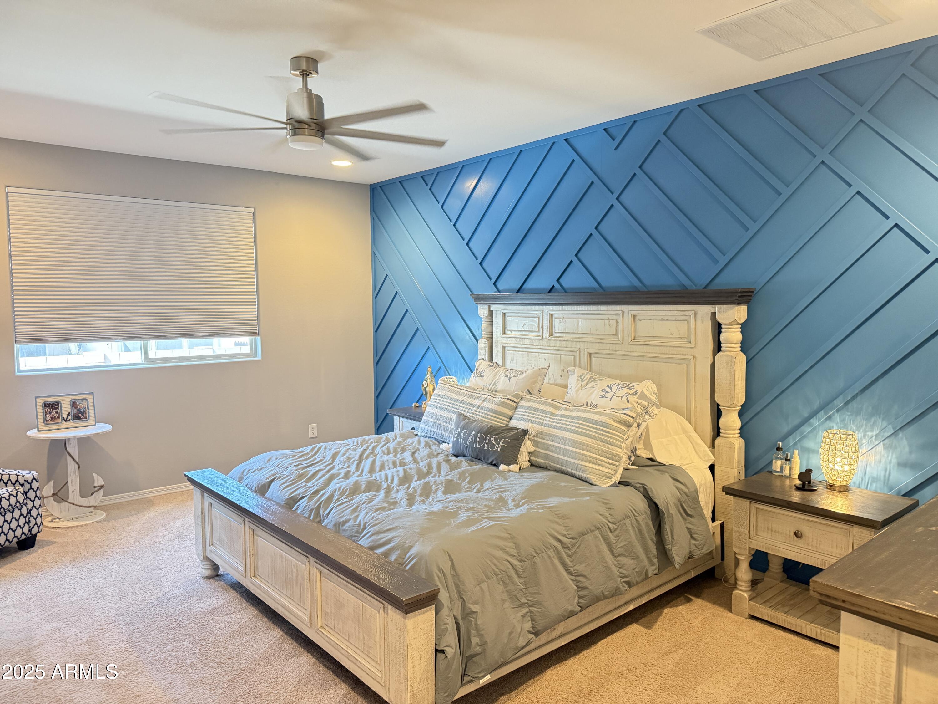 6980 West Redbird Road Peoria, AZ 85383 - Photo 16 of 31 a bedroom with a bed and window