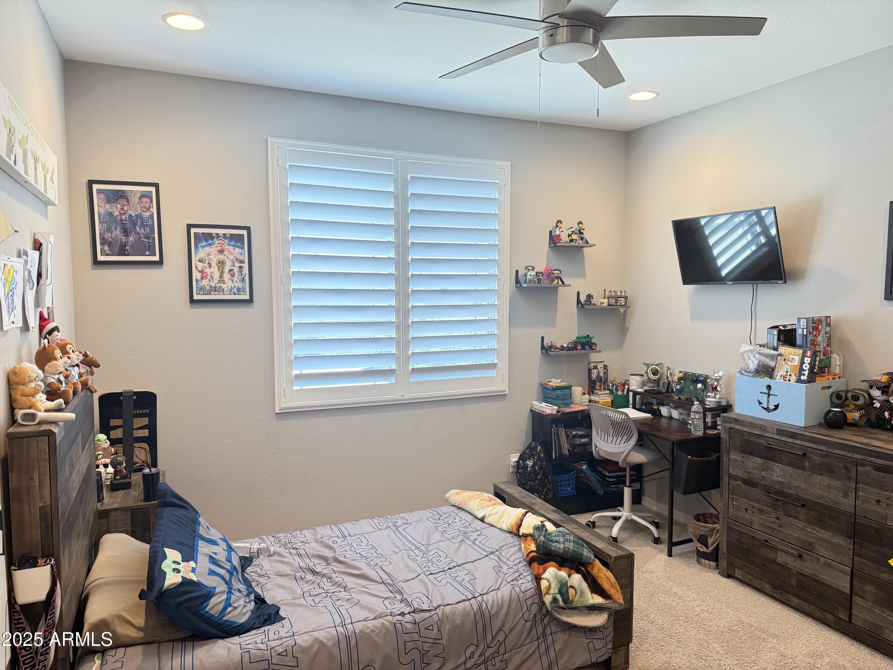 6980 West Redbird Road Peoria, AZ 85383 - Photo 18 of 31 a bedroom with a bed and a computer on a desk
