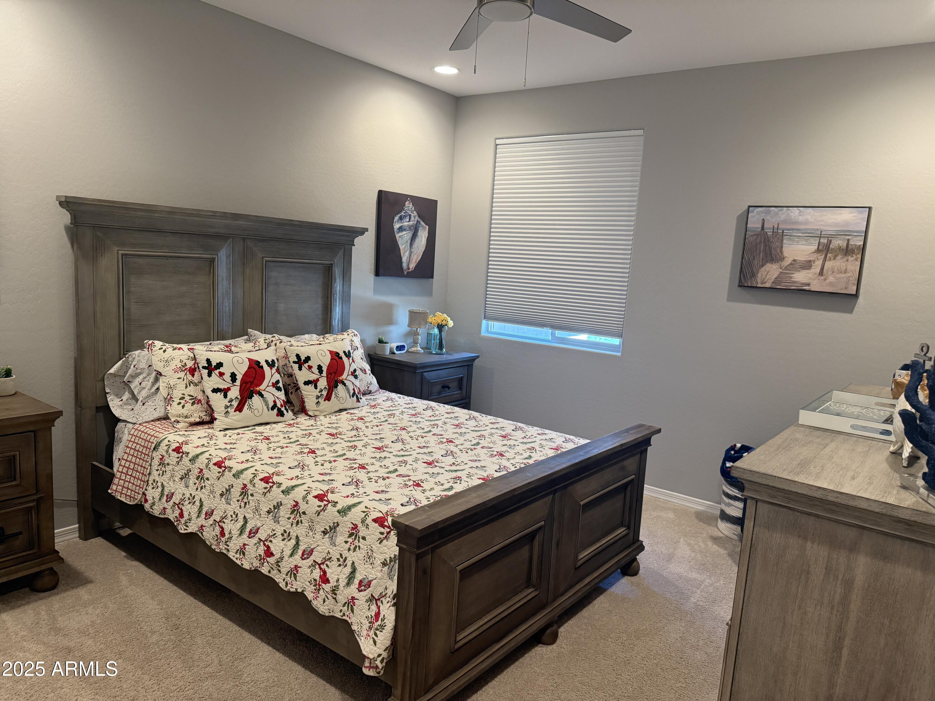 6980 West Redbird Road Peoria, AZ 85383 - Photo 24 of 31 a bedroom with a bed and a table in it