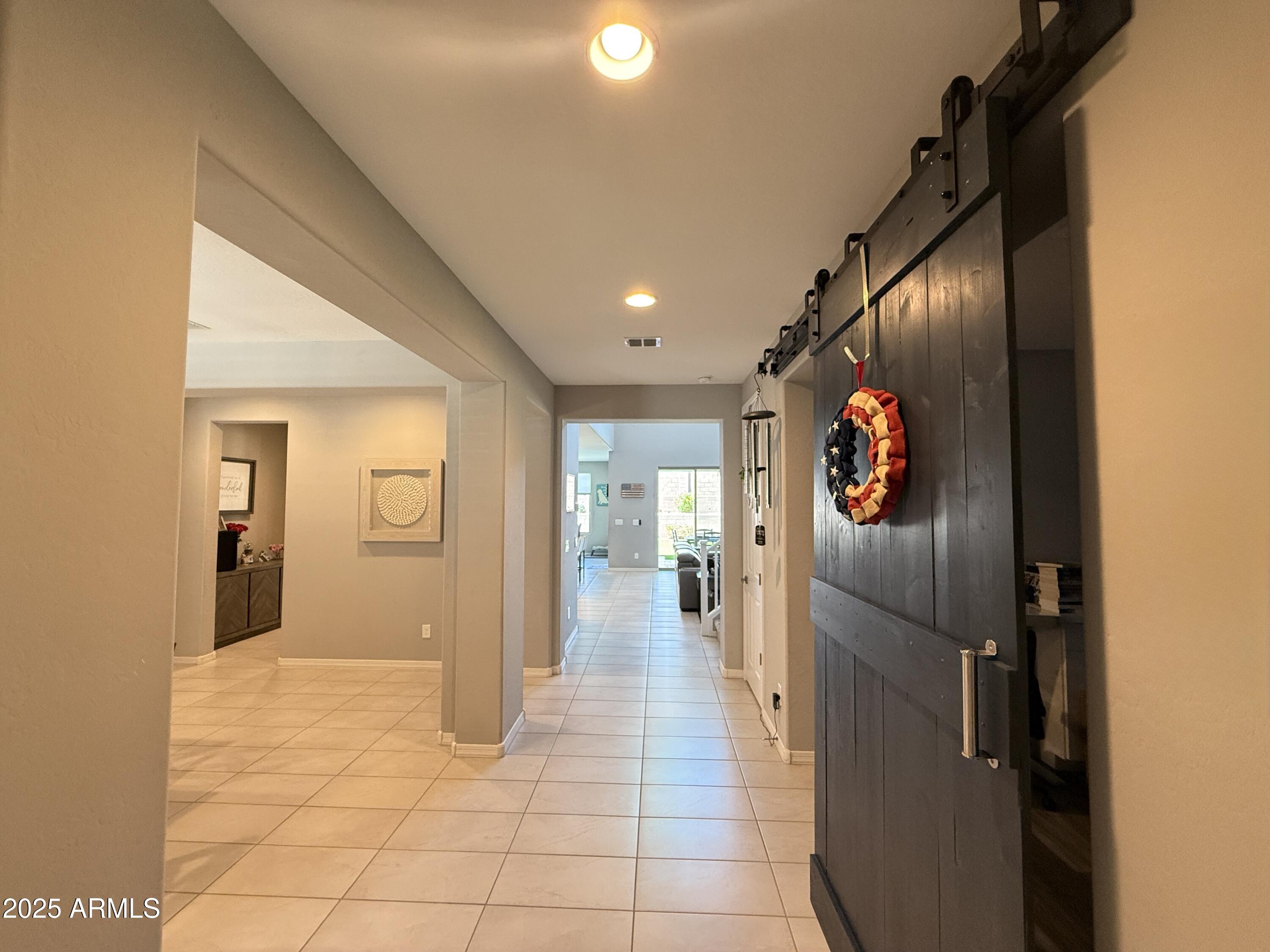 6980 West Redbird Road Peoria, AZ 85383 - Photo 4 of 31 a view of a hallway with wooden floor