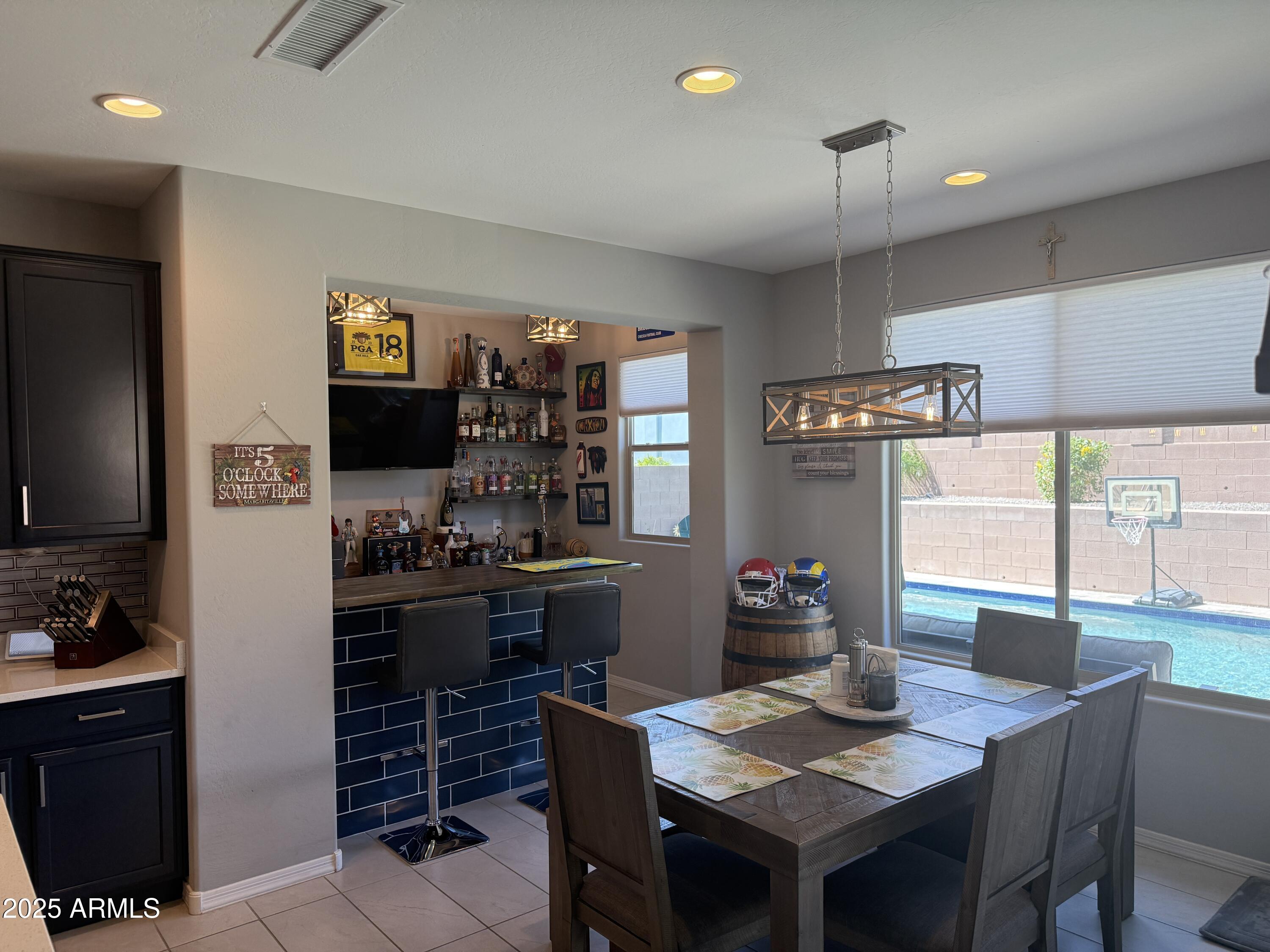 6980 West Redbird Road Peoria, AZ 85383 - Photo 8 of 31 a kitchen with a stove a sink and a refrigerator