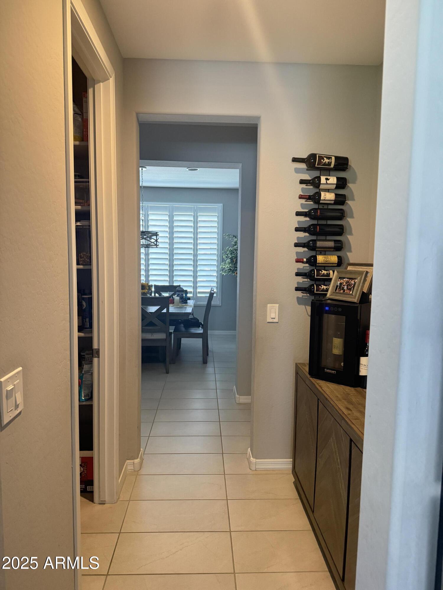 6980 West Redbird Road Peoria, AZ 85383 - Photo 9 of 31 a view of a hallway and a livingroom with furniture