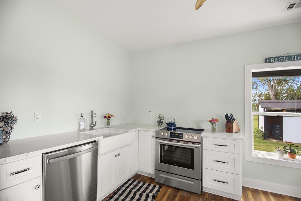 775 Colbert Bridge Road Windsor, SC 29856 - Photo 22 of 33 a kitchen with stainless steel appliances a white stove top oven and sink