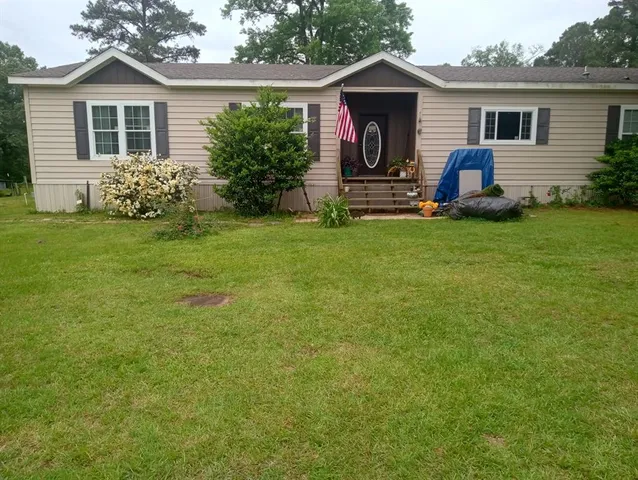a front view of house with yard and outdoor seating