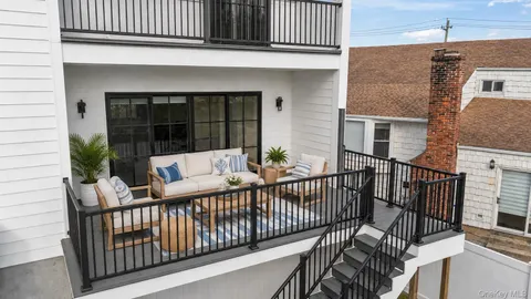 a view of a house with a wooden deck