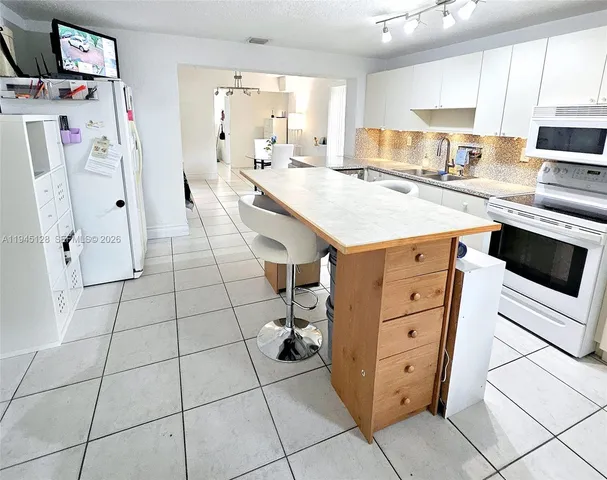 a kitchen with stainless steel appliances cabinets and a counter top space