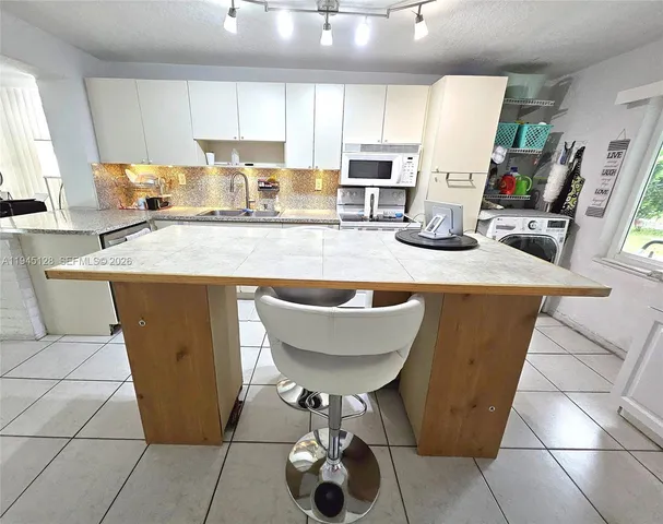 a large white bed in a white room