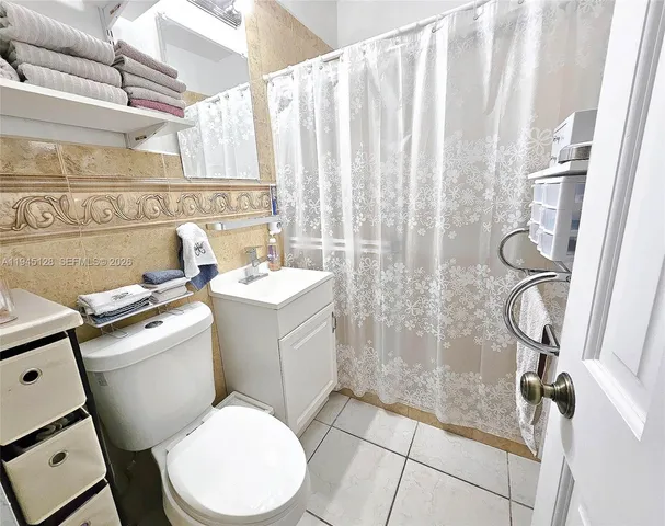 a living room with a table chair and a window