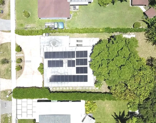a front view of a house with a yard and lake view