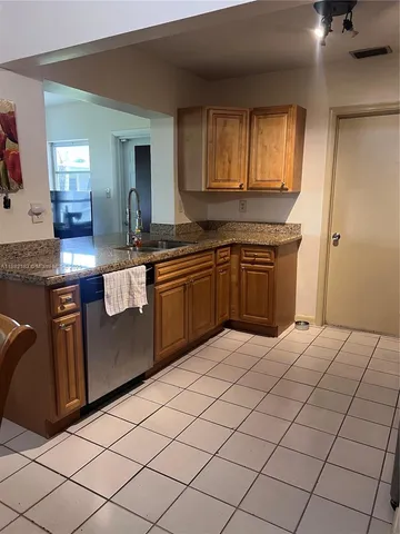 a kitchen with stainless steel appliances granite countertop a sink and cabinets