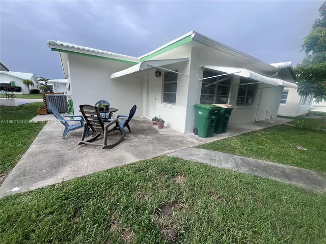 a view of a house with backyard sitting area and porch