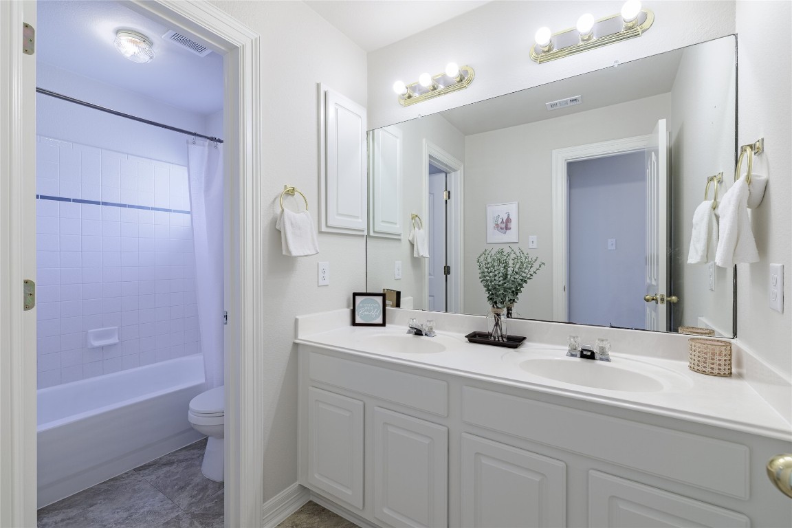 205 Ridge Run Court Georgetown, TX 78628 - Photo 10 of 40 a bathroom with a double vanity sink and mirror with bathtub