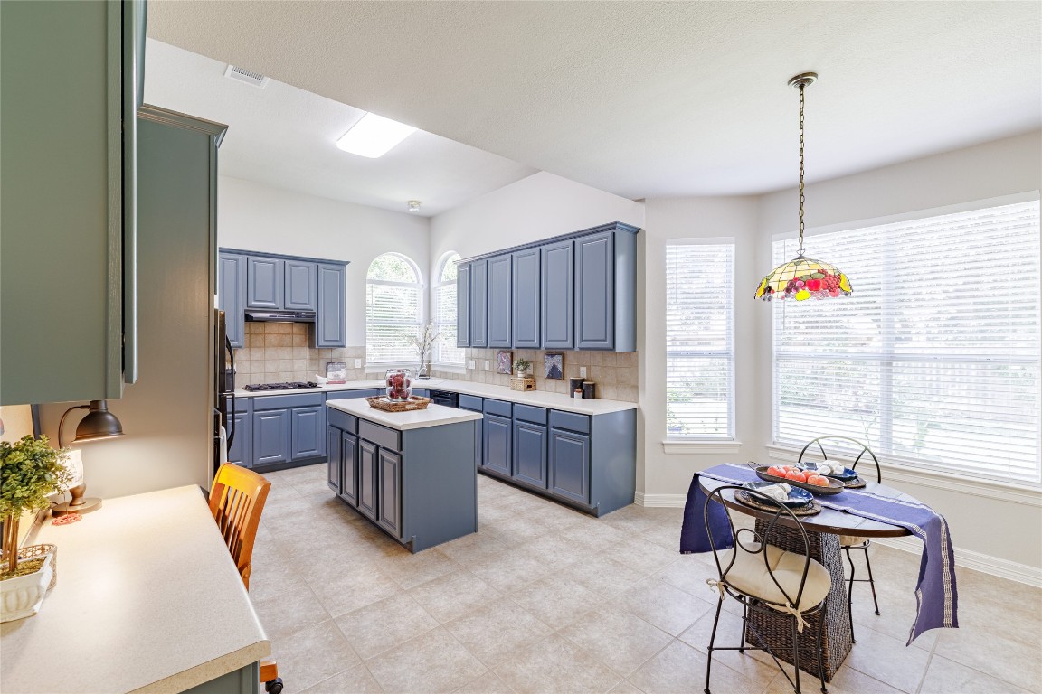 205 Ridge Run Court Georgetown, TX 78628 - Photo 20 of 40 a kitchen with a refrigerator and a stove top oven