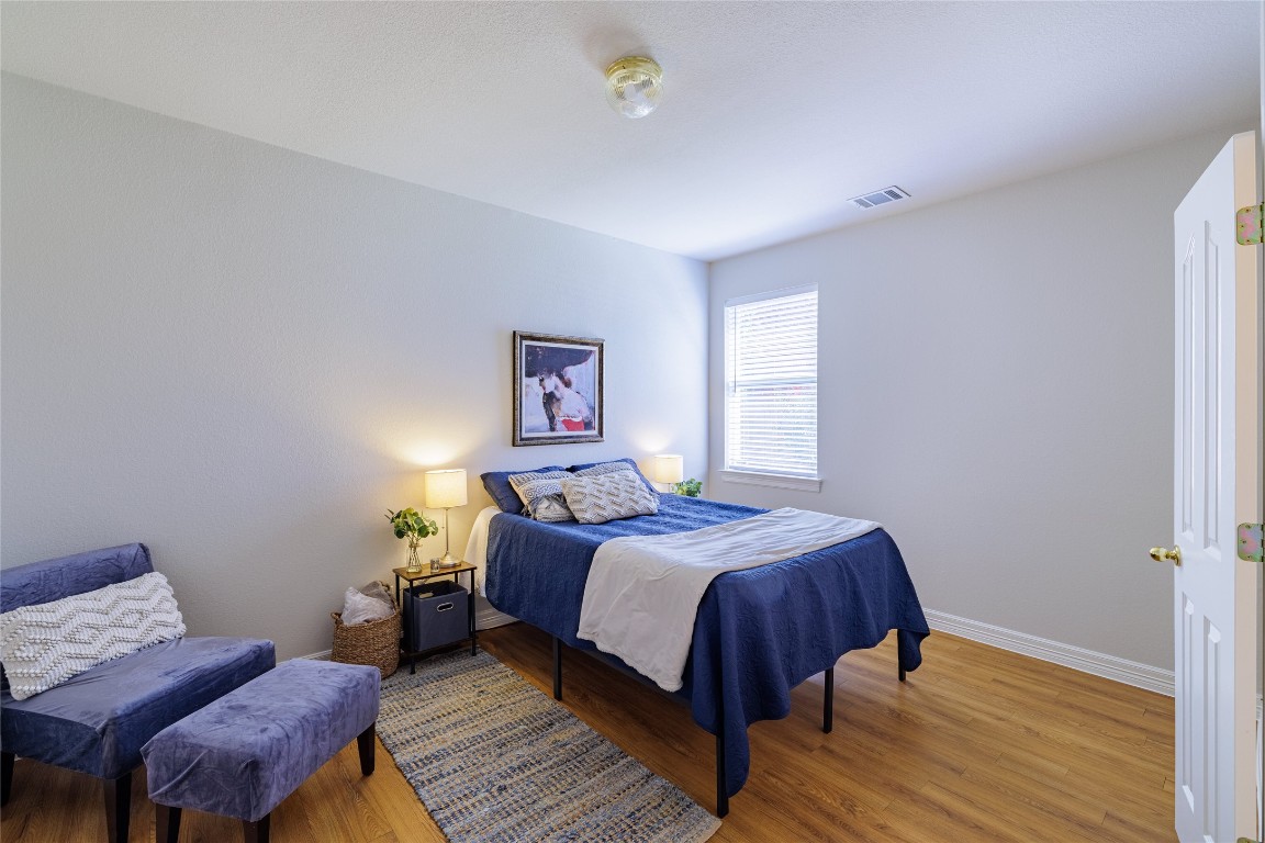 205 Ridge Run Court Georgetown, TX 78628 - Photo 23 of 40 a bedroom with a bed and wooden floor