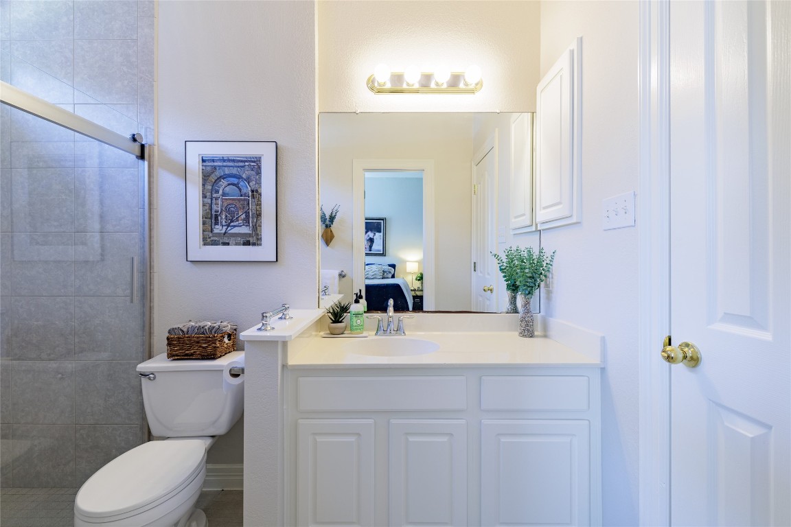 205 Ridge Run Court Georgetown, TX 78628 - Photo 24 of 40 a bathroom with a sink vanity mirror and toilet