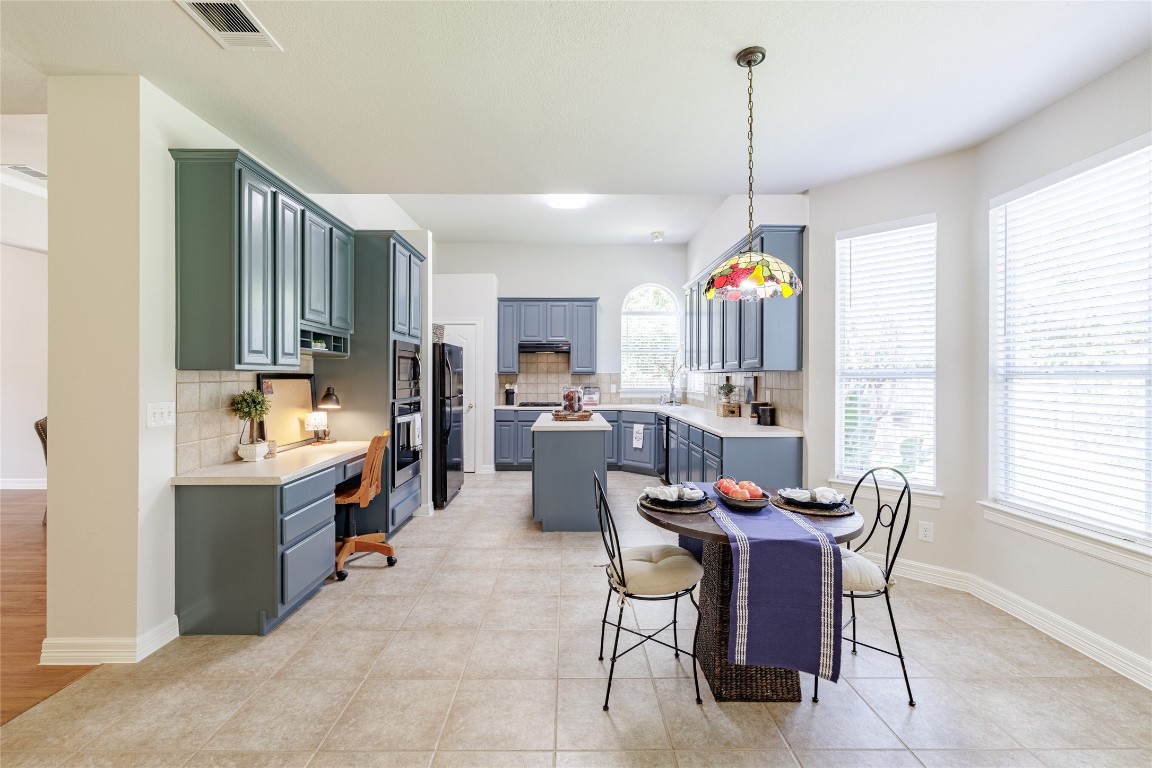 205 Ridge Run Court Georgetown, TX 78628 - Photo 4 of 40 a dining room with furniture a chandelier and window