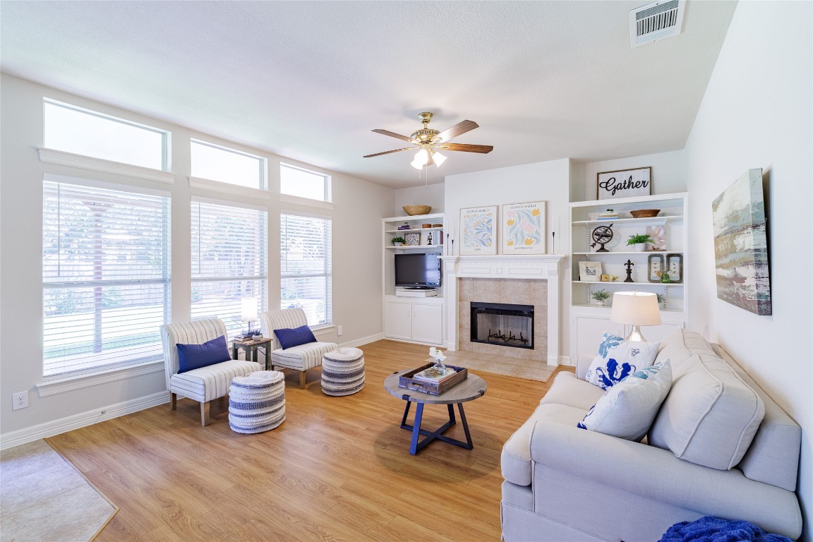 205 Ridge Run Court Georgetown, TX 78628 - Photo 5 of 40 a living room with furniture a fireplace and a large window