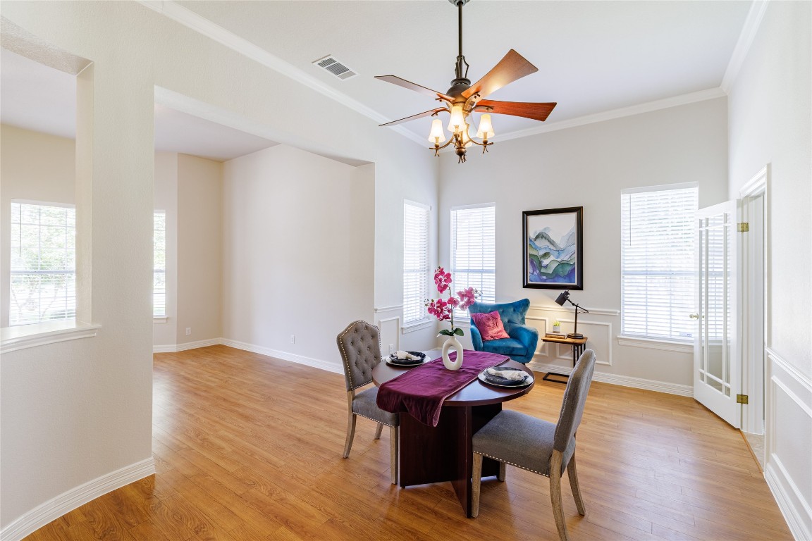 205 Ridge Run Court Georgetown, TX 78628 - Photo 6 of 40 a dining room with furniture a chandelier and wooden floor
