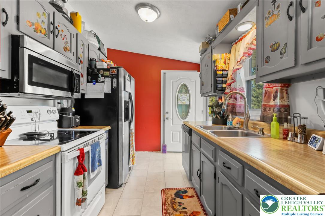 4354 2nd Street Walnutport, PA 18088 - Photo 5 of 21 a kitchen with stainless steel appliances a sink a stove and a refrigerator