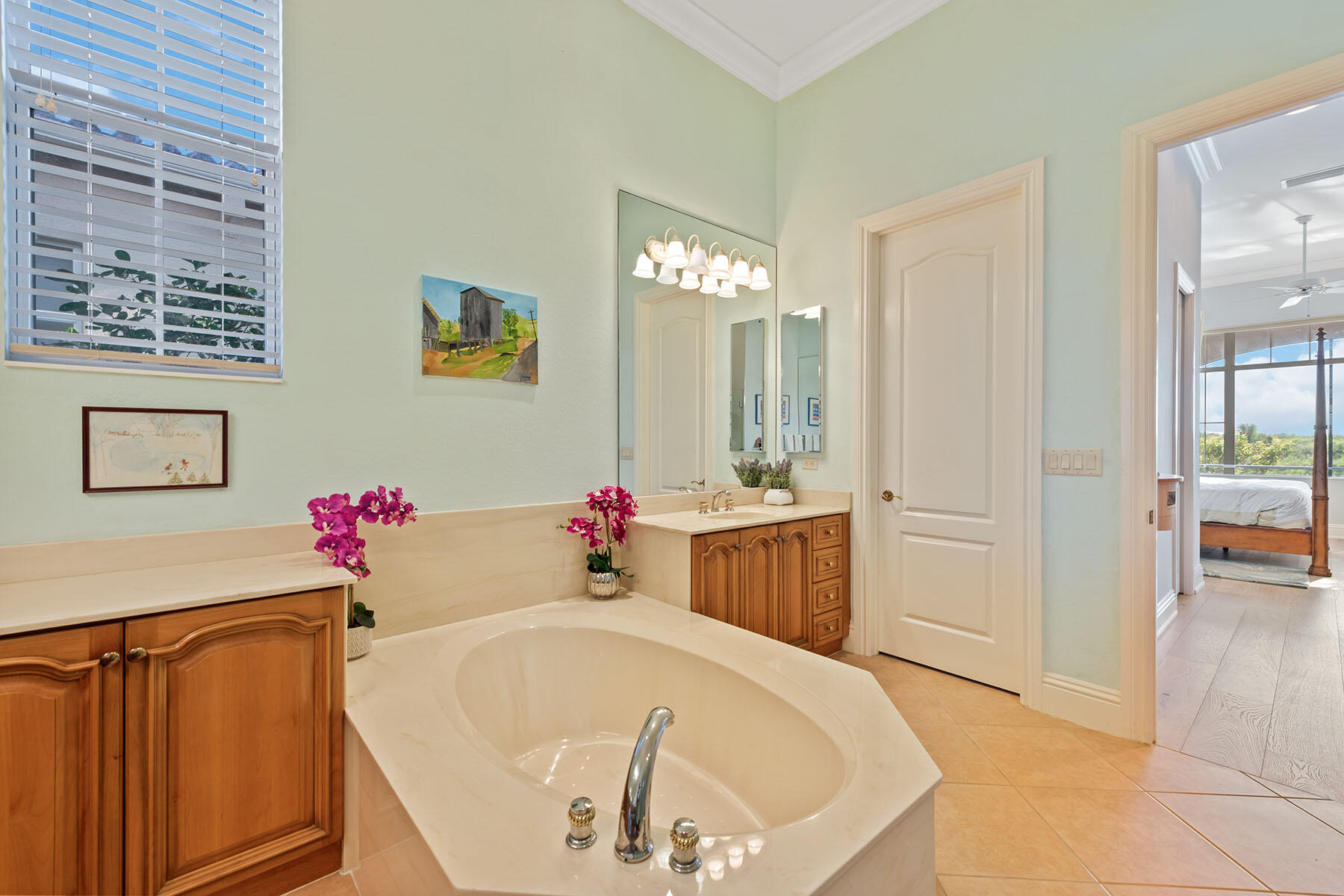 8528 Bellagio Drive Naples, FL 34114 - Photo 12 of 50 a bathroom with a tub sink and mirror