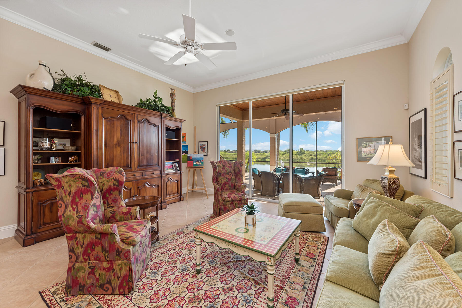 8528 Bellagio Drive Naples, FL 34114 - Photo 17 of 50 a living room with furniture a lamp and a chandelier