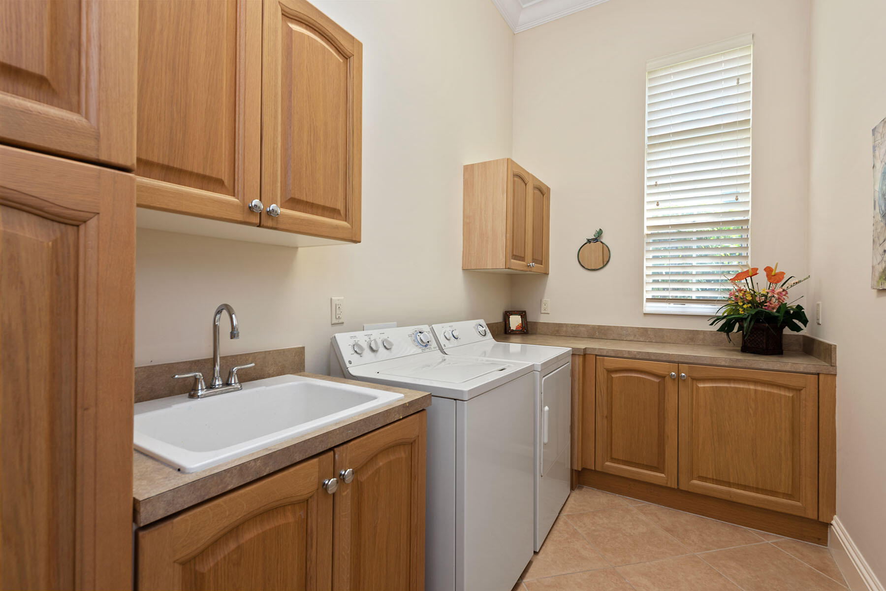 8528 Bellagio Drive Naples, FL 34114 - Photo 21 of 50 a utility room with cabinets washer and dryer