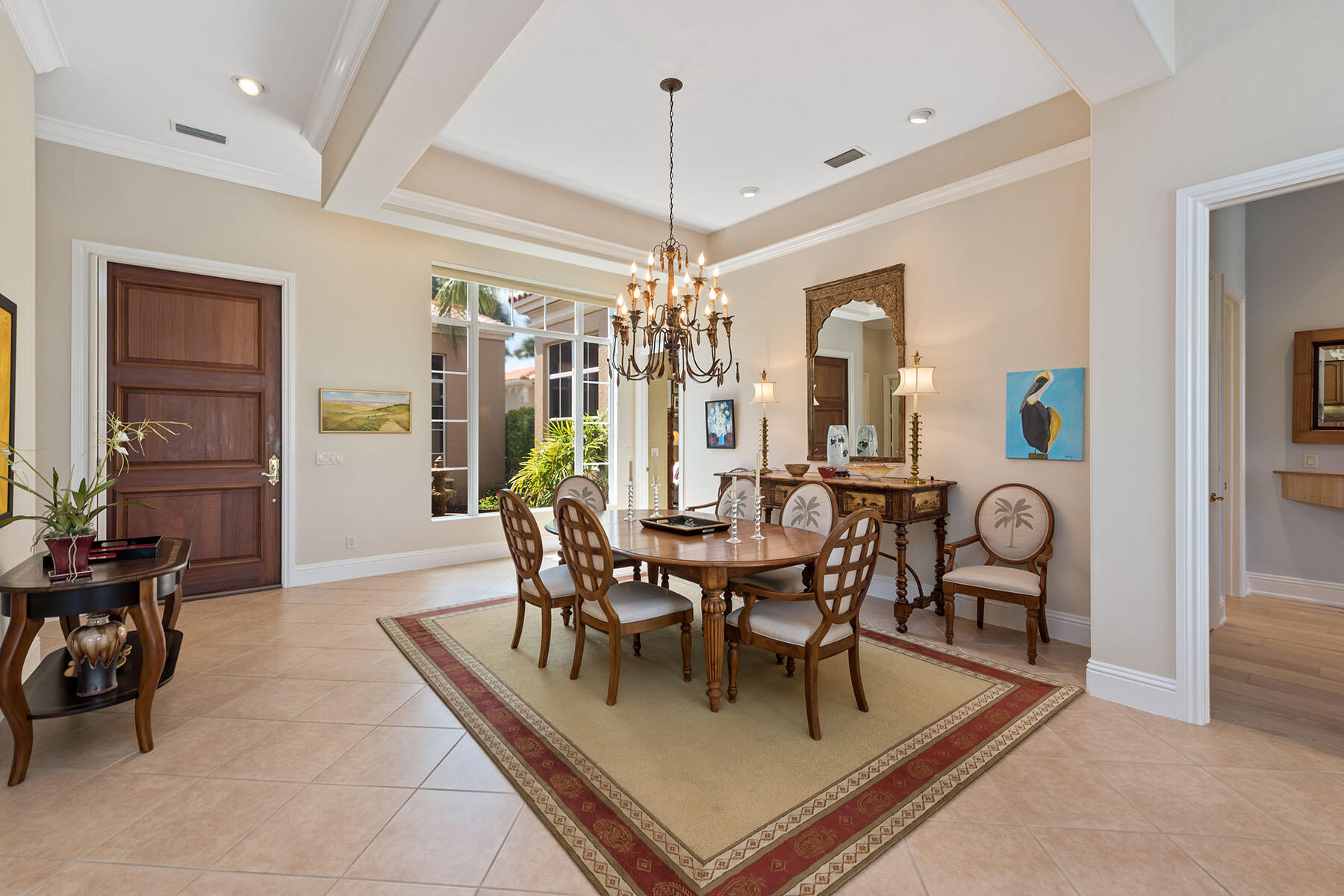 8528 Bellagio Drive Naples, FL 34114 - Photo 9 of 50 a dining room with furniture a chandelier and window