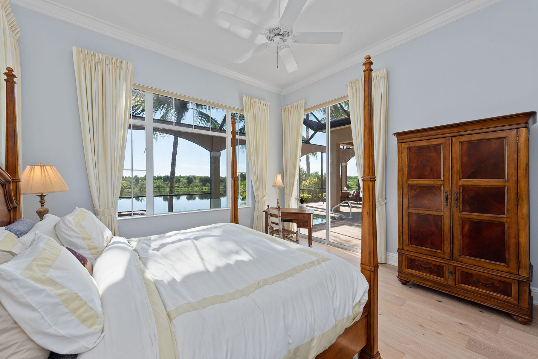 8528 Bellagio Drive Naples, FL 34114 - Photo 10 of 50 a bedroom with a bed and a large window