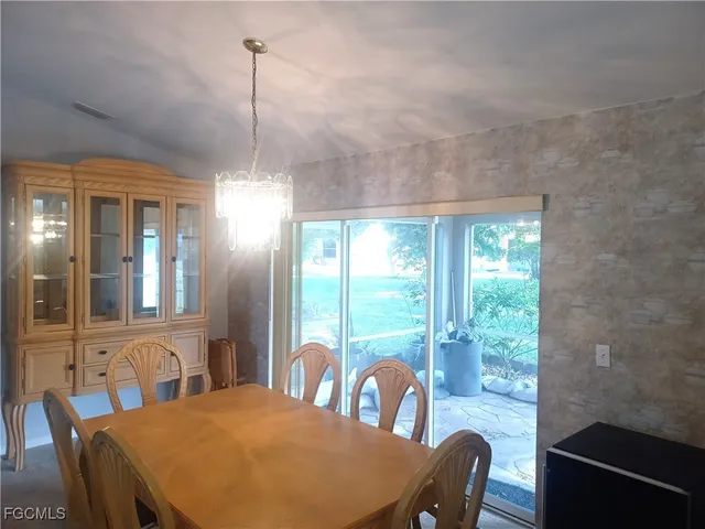 a kitchen with granite countertop white cabinets and stainless steel appliances