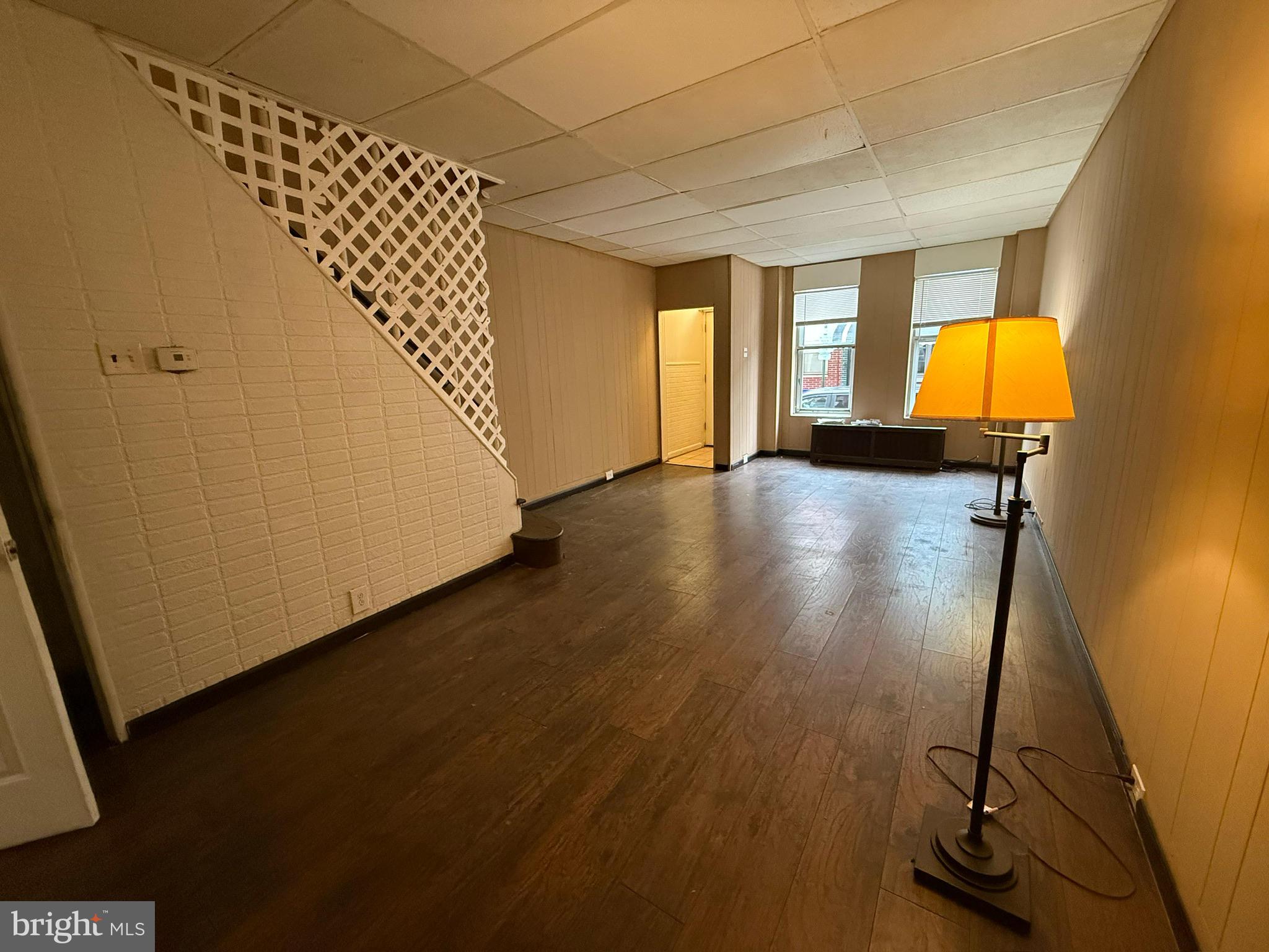 1816 South Chadwick Street Philadelphia, PA 19145 - Photo 3 of 8 wooden floor in an empty room with a window