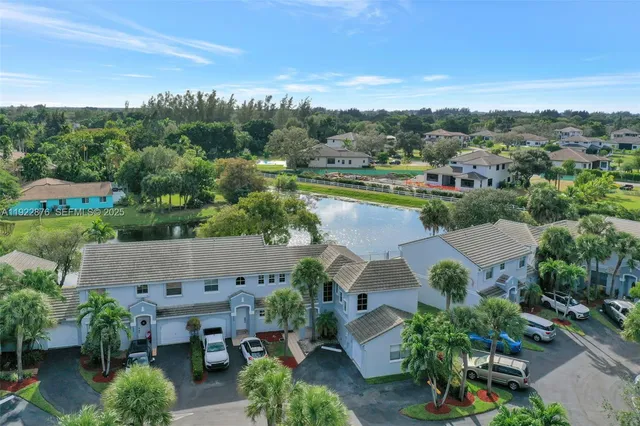 an aerial view of a house with outdoor space and lake view